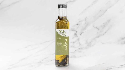 Extra Virgin Olive oil white black green pepper and bay leaves